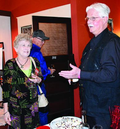 Maria Patterson checked out John Rogotzke’s wine and chocolate table at Saturday’s Chocolate Festival. Proceeds from the event benefited the Scurry County Museum.