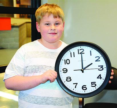 Michael Woodard, a fifth grade student at Ira ISD, reminds everyone to set their clocks ahead one hour Saturday night when daylight saving time begins. Daylight saving time begins at 2 a.m. Sunday.