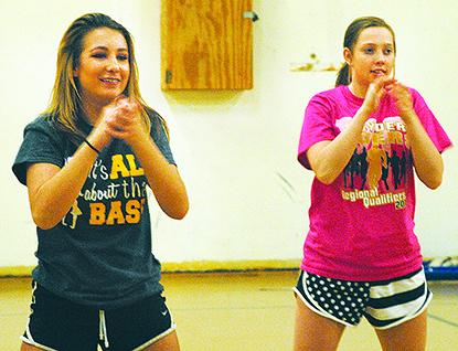 Snyder High School spirit team members Kaylee Klein (left) and Shelby Meador practice their routines Thursday. Snyder will participate in the first University Interscholastic League state spirit competition in Arlington Thursday.