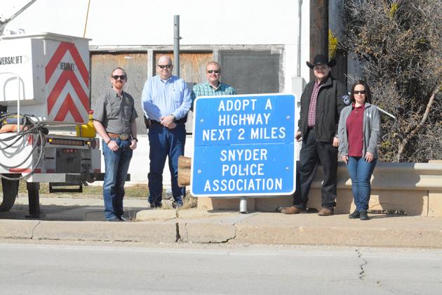 The Snyder Police Association (SPA) has adopted two miles of highway on U.S. Hwy. 180. Pictured with the new road sign are (l-r) SPA vice president J.P. Wilson, Police Chief Brian Haggard, Lt. Mike Counts, SPA president Josh Reeves and SPA board director Lee Tarter.