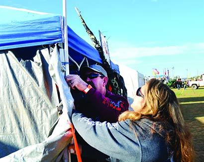 Scoop Berringer (left) and Debbie Chavez, of Deming, N.M. set up their booth, Scoops HD Deals, at the Snyder Bike Rally this morning. The Snyder Bike Rally will be held through Saturday night at the rodeo grounds on Gary Brewer Road.