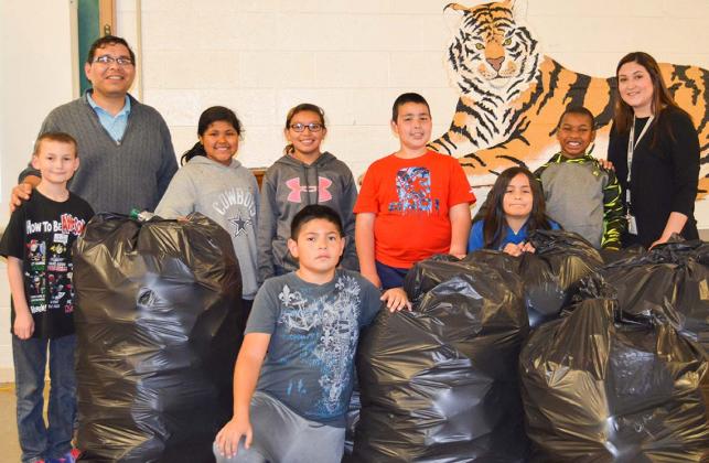Students in the Afterschool Centers on Education (ACE) Recycle Me classes have been collecting and preparing plastic bottles at Snyder Intermediate School for this year’s bottle challenge. The Siberian class is pictured with the collected bottles. Pictured are (l-r) Michael Cheyne,  ACE support staff Jose Morales, Idalee Rodriguez, Gabby Garcia, Xavier Sigarillo, Bryan Block, Christoper Havner, Daenin Smith and ACE facilitator Isrell Lawson. 