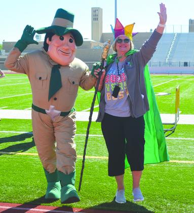 Snyder Primary School won the Earth Day Bottle Challenge for the fourth consecutive year, collecting 96,095 bottles. Principal Canita Rhodes accepted her trophy from mascot Major Green (left).