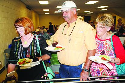 From left, Vicky Williams, Danny Williams and Barbara Burney waited to be served during the burgers and beans dinner at the West Texas Western Swing Festival on Wednesday. Music at the festival began today and continues through Saturday at The Coliseum.
