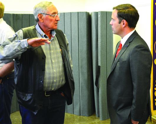 Carl Burleson (left) speaks with State Rep. Dustin Burrows after Burrows spoke at a luncheon held by three service clubs Tuesday. 