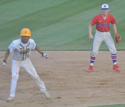 Snyder’s Cameron Smith (left) takes a lead off second base while Graham shortstop Alex Strawbridge watches a pitch during Thursday’s bi-district playoff game at Moffett Field. The Steers scored two runs in the bottom of the 11th inning Saturday to claim a 9-8 win to win the series.