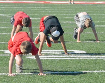Hermleigh ISD athletes (l-r) Tanner McCombs, Alex Wanderlich, Talyn Chavez and Camden Elder stretched before the start of workouts at Cardinal Stadium Wednesday. More than 40 boys and girls showed up for the morning workouts.