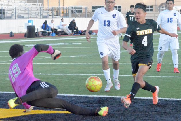 Snyder junior Christian Escobedo (right) shoots the ball past a diving Lubbock Estacado goalkeeper during the Tigers’ win at Tiger Stadium Friday. Escobedo and Daniel Esparza each scored two goals.