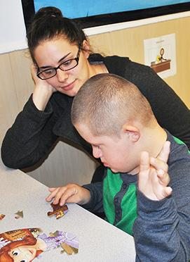 Baxter worked on a puzzle with his teacher Malina Roux. 