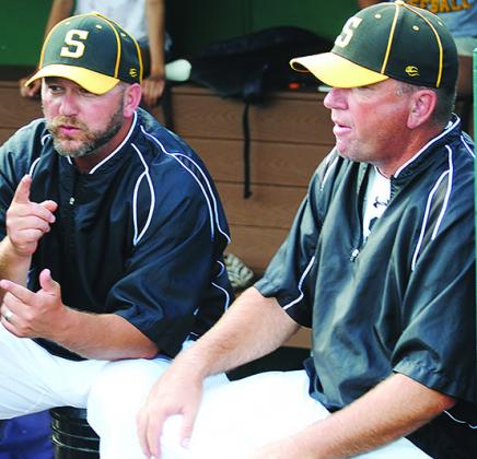 Snyder assistant baseball coach David Tate (right) talks with assistant coach John Moffett during last weekend’s playoff game against Abilene Wylie. Tate, who became assistant principal at Snyder High School in January, was an assistant coach the past 12 years.