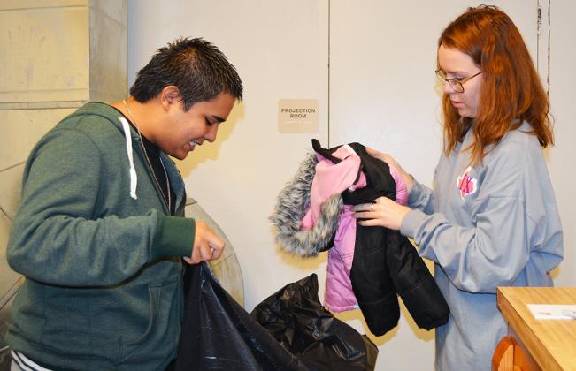 The Snyder High School publications department has collected approximately 100 coats and several toys for its ninth annual coat and toy drive, which began in mid-November. Collected items will be donated to Gateway Family Services. Donations for coats and toys may be dropped off at the school office until Thursday. Pictured sorting coats are students Ruben Munoz (left) and Rebecca McDowell.