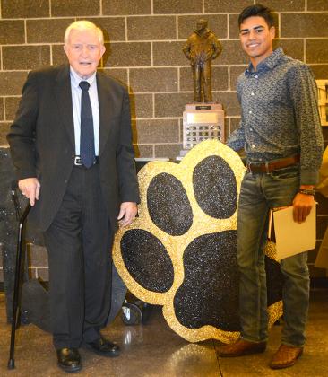 The 17th Grant Teaff Character Award Winner, senior Corey Landin (right), stood next to the trophy with Grant Teaff during the Snyder football banquet, which was held in the Snyder High School Cafeteria Sunday. Landin is the first skill position player to win the award since it’s conception in 2003.