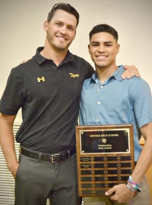 Snyder athletic director Wes Wood (left) presented Snyder senior Corey Landin with the Outsanding Male Athlete award. Landin competed in football, basketball, cross country and track.