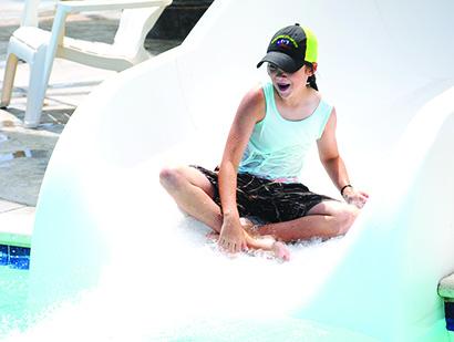 Payton Foster, 10, went down the slide at the Scurry County pool at Towle Park on Tuesday. The pool and splash pad will be open through Aug. 14 before closing for the fall. 
