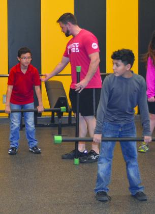 Snyder Junior High School Afterschool Centers on Education (ACE) students Ean Terrazas (left) and Nicholas Delao (right) participated in the CrossFit Kids program Monday evening with instructor Ryan Grinnell. 