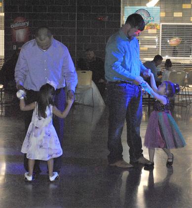 Benjamin and Aubriana Gutierrez (left), and David and Alys Kreher danced at Saturday’s Shining Stars Sports and Recreation Father-Daughter Dance in the High School Cafeteria. 