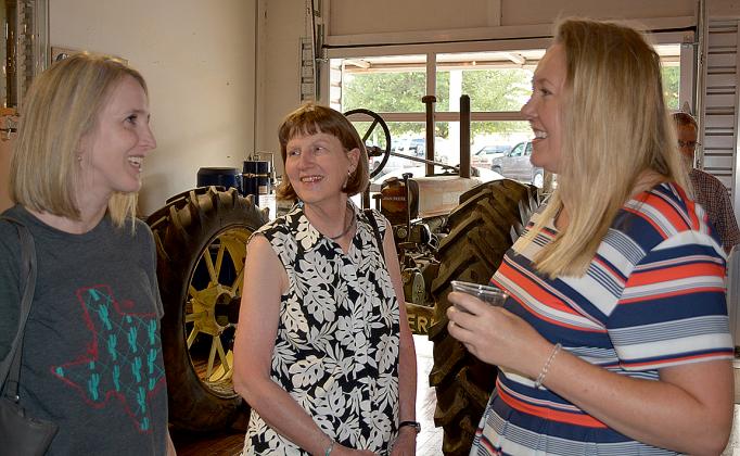 Scurry County Museum Executive Director Nicole DeGuzman (right) visited with Meagan Rosson (left) and Carol Bullard during a welcome reception at the Development Corporation of Snyder office Thursday evening.