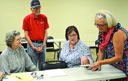 Pictured are (l-r) M.J. Merritt, Sonny Greenfield, Camille Reed and Paula Hatfield looking at older photographs of the Santa Fe Depot. The Scurry County Historical Commission and Scurry County Museum accepted information and pictures about the depot Thursday at College on the Square.