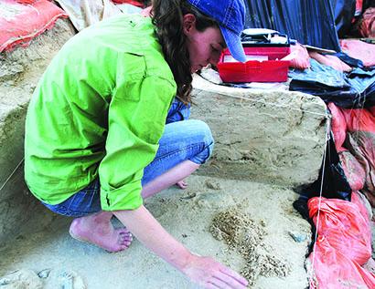 Lyla Jones, one of the team members for the paleontology team at Roland Springs Ranch, dug up part of an ancient turtle shell at the dig site Wednesday. Tours of the dig site will begin Saturday at 10 a.m.