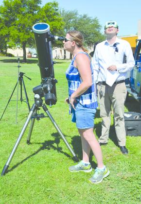 Western Texas College professors Dana Fahntrapp (left) and Floyd Holder viewed the solar eclipse on campus Monday afternoon. At the peak viewing time in the region, the moon appeared to cover about 80 percent of the sun’s surface just before 1 p.m. 