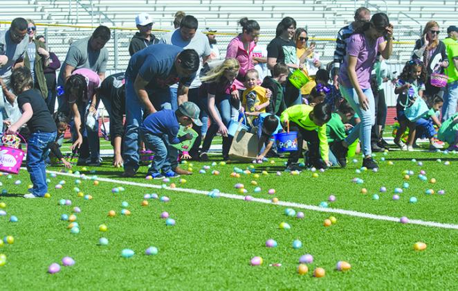 Children and their parents rushed to scoop up eggs as the hunt began.