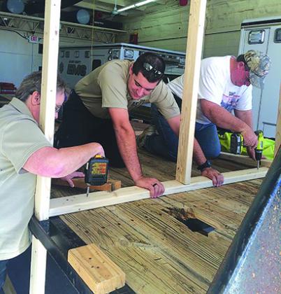 Pictured are (l-r) Cindy Josey, Jaffin Durham and Russel Thomas working on the Scurry County EMS parade float for today’s lighted parade, which will begin at 6:30 p.m. 