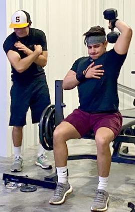 Snyder junior Austin Escobedo (left) and his brother, Aaron Escobedo, get in a workout at their home. Escobedo is a pitcher for the Snyder Tiger baseball team