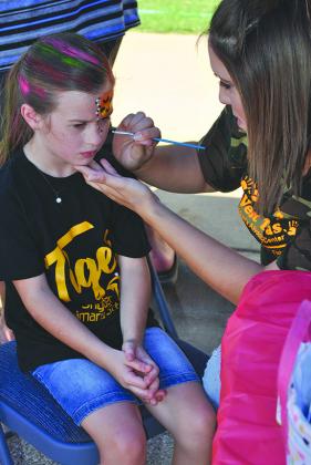 Morgan Hale (left) had her face painted by Kelsey Zimmerman.