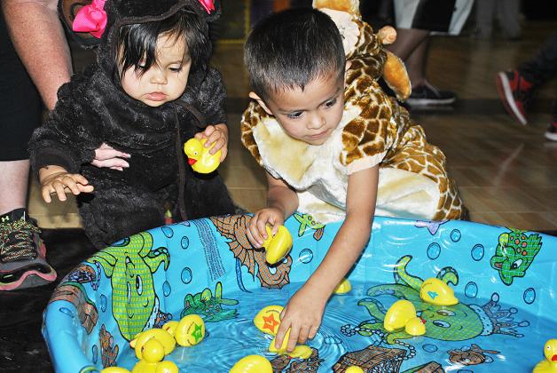 Electra and Syler Alvarez picked ducks from a pond at Family Fall Fest at the Scurry County Boys and Girls Club on Saturday