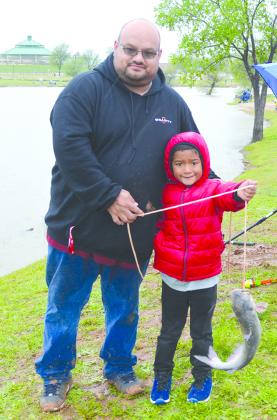 Robert Garza (left) and his son, Robert Garza Jr., caught a fish within the first 30 minutes of Saturday’s Fish-a-Thon.