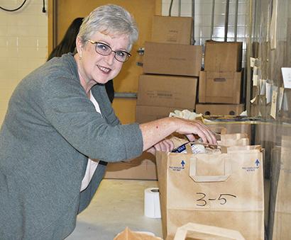 Volunteer Karren Wadleigh sacked food Tuesday at the Scurry County Food Cupboard.  