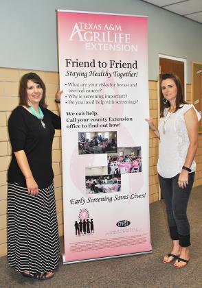 Scurry County Extension Agent Ronda White (left) and Renee McClurg, Extension Office manager, stand next to the banner for Monday’s Friend-to-Friend program, which will raise awareness of breast and cervical cancer. The program will begin at 5:30 p.m. in the Colonial Hill Baptist Church fellowship hall.