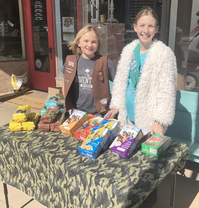 Girl Scouts Olivia Burns (left) and Mya Hale manned a Girl Scout cookies stand outside of Bucks & Bows on Saturday.