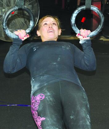 Isabel Villa performs Bulgarian ring rows while training for the event.