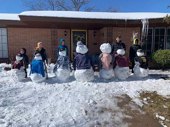 Snyder’s Green family poses with the snow family they built. Pictured (l-r) are Gryffon Green, Gideon Green, Jaxson Green, Boston Green and Torron Green.