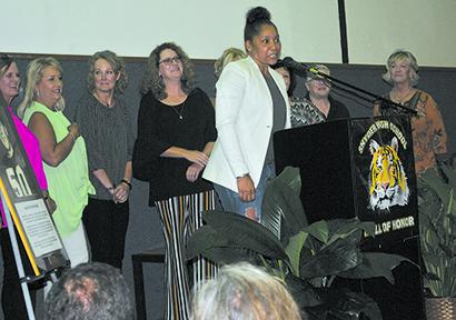 Karlene Thompson (center) spoke about the 1985 state champion volleyball team as her teammates listened behind her.