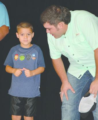 Following a long-standing tradition, Hermleigh ISD seniors introduced the kindergarten students during the first-day assembly this morning. Austin Sandoval (right) introduced Mathias Stowe.