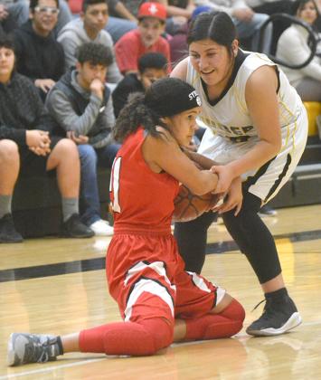 Hermleigh’s Syreah Callaway (left) battled with Snyder’s Jasmine Hernandez during the Lady Cardinals’ 35-26 win over the SJHS eighth grade A-Team Saturday.