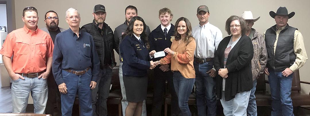 Ira FFA Members Lilly Juarez and Karson Valentine (sixth and seventh from left), receiveda scholarship check from Hunter Appreciation board members Tuesday. Pictured are (l-r) Reese Grimmett, Kenny Miller, Drew Bullard, Jason Bynum, Ira ISD teacher Leo Sellers, Juarez, Valentine, Jamie Price, Brad Hart, Melissa Kruger, Richard Kruger and Dennis Taylor.