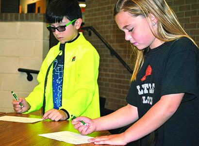 Ira third graders Oscar Martinez (left) and Landry Cumbie register to vote in the upcoming Ira ISD mock election. Students will cast their votes on Nov. 7. 