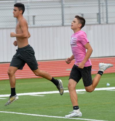 Snyder High School athletes Jaden Hernandez (left) and Hunter Stewart finished a sprint during summer workouts at Tiger Stadium earlier this summer. This week is the final week of summer workouts before pre-season practices begin on Aug. 3.