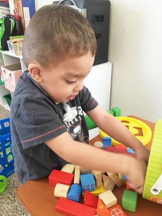 Jake Realsola, who suffers from Noonan syndrome, enjoys playing with toys and engaging in other activities. Realsola receives humidified oxygen several times a day so his lungs do not dry out.