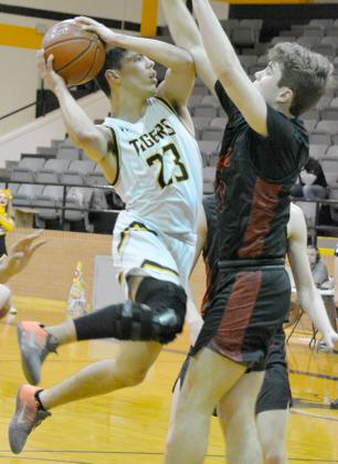 Snyder senior Jayden Samaniego shot a layup as an Argyle defender got in his way during the Tigers’ 44-28 loss Friday. Samaniego finished his career as a three-year letterman for the Tigers.