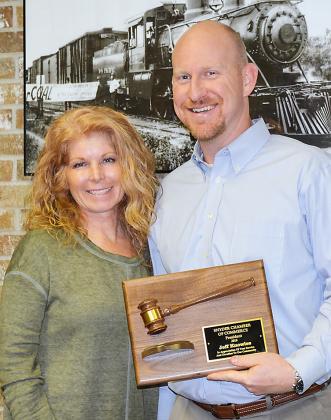 Snyder Chamber of Commerce Executive Director Linda Molina (left) presented outgoing chamber board president Jeff Knowles with a plaque recognizing his service during Monday night’s chamber board meeting. 