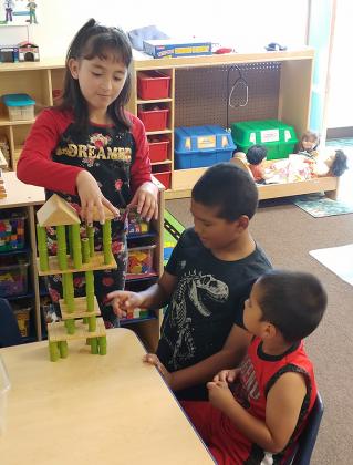 From left, Jahdira Gonzalez, Angel Ramirez and Gael Aguinaga show off their construction skills in Rachael Bass’ and Solidad Guzman’s classroom during Jumpstart Enrichment for Tomorrow’s Students’ (JETS) open house Wednesday afternoon.