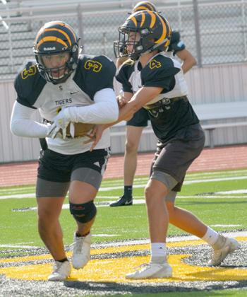 Snyder junior Jorge Olivarez (3) took a handoff from junior Hunter Stewart during practice at Tiger Stadium Thursday. The Tigers held the Watermelon Bowl intrasquad scrimmage Saturday.