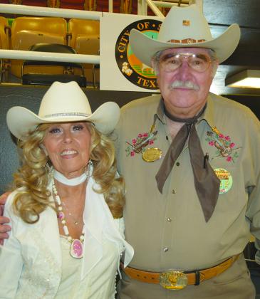 Western Swing Monthly representatives Barbara Terry (left) and Joe Liles set up a booth at the West Texas Western Swing Festival at The Coliseum this week.