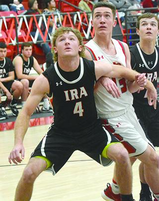 Hermleigh 2020 graduate Kobe Roemisch (center) battled with 2020 Ira  graduate Karson Valentine (left) and Ira junior Ike Weaver for position during a game last season. Both Roemisch and Valentine made The Snyder News All-Decade series basketball team.
