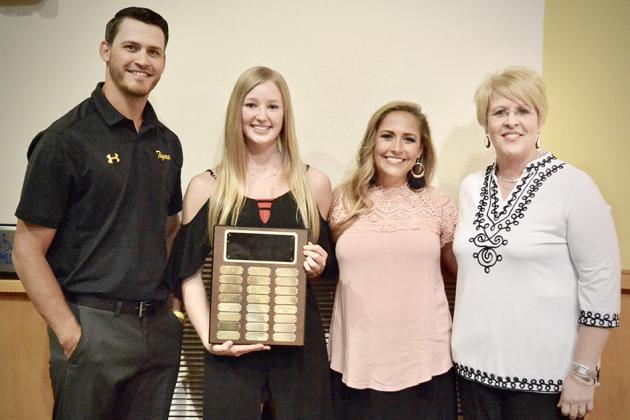 Kendra Bynum (second from left) received the Bill J. Hood Scholar Athlete award from Wood, Eicke and Snyder High School principal Janell Martin. Bynum competed in volleyball. 