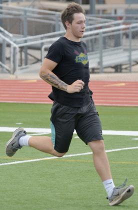 Snyder High School junior Kyler Teakell finished a sprint during morning workouts at Tiger Stadium Tuesday. Snyder athletes returned to summer workouts on Monday.